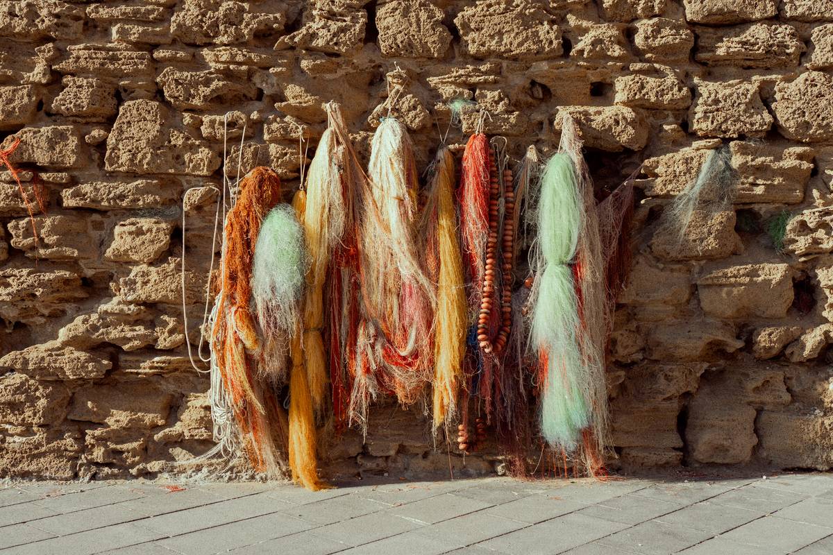 Close-up of intricate wall hanging decorations with macrame knots and fringe detail