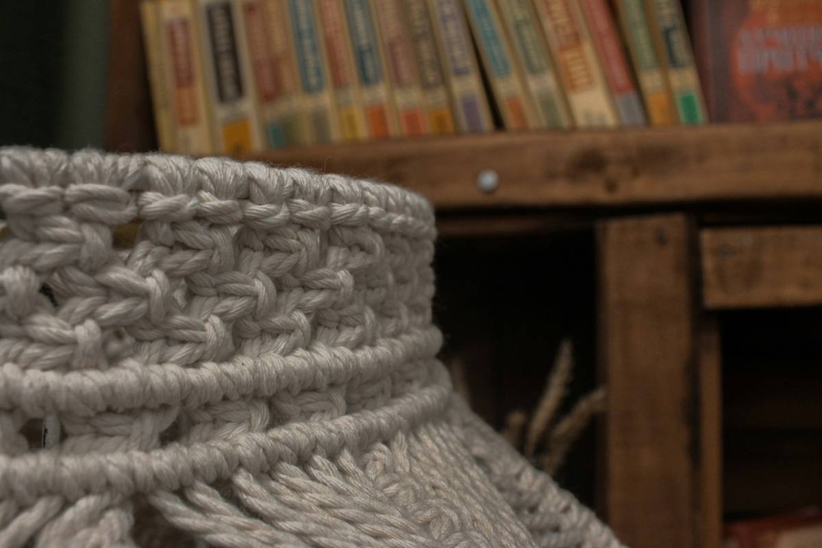 macrame art wall hanging tutorial showing beginner practicing square knots on cotton cord mounted on wooden dowel