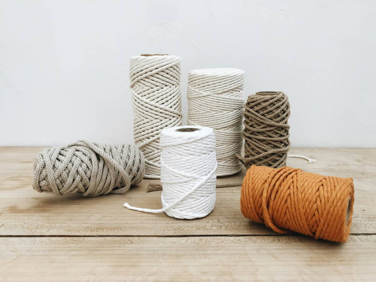 macrame wall hanging diy in progress on a wooden dowel with natural cotton cord