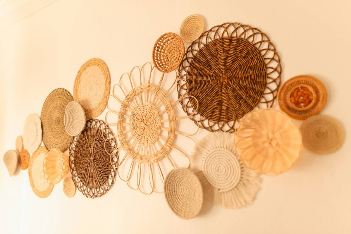 macrame wall art hanging with natural cotton cords on wooden dowel against white wall